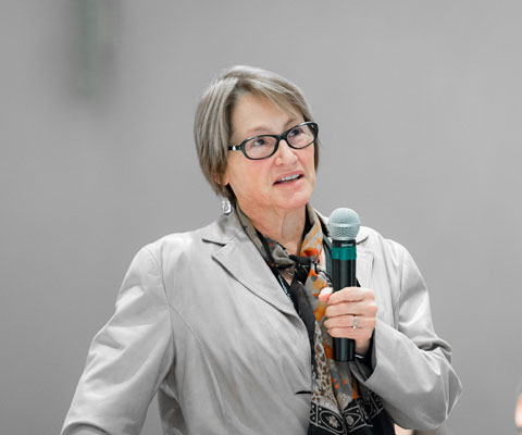 Suzanne Fortier, principal of McGill University, speaking with a microphone.