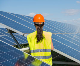 Female working on solar panel 