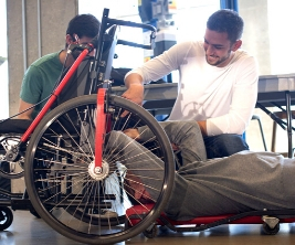 3 males working in a wheelchair