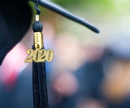 A close-up image of a graduation cap and tassel with a small pendant hanging from the tassel that reads “2020.”