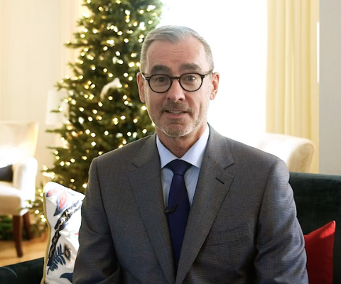 Bill Flanagan, president of the University of Alberta, sits in his living rooms to deliver a virtual greeting.