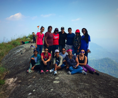 Students group photo siting in the top of mountain
