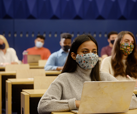 Students Sitting in class room wearing face mask 