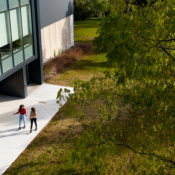 Aerial image of a campus building with students outside