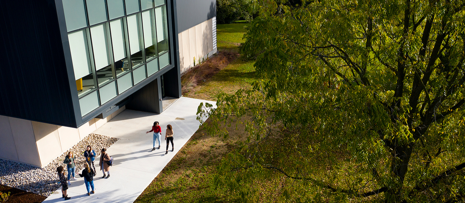 Aerial image of a campus building with students outside