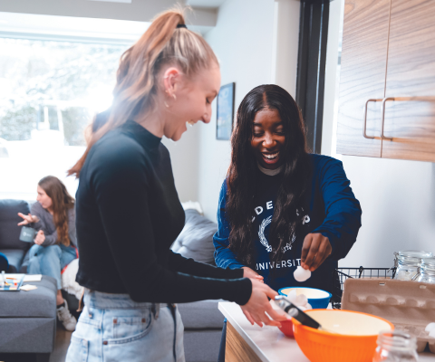 Two female students baking in a dorm room