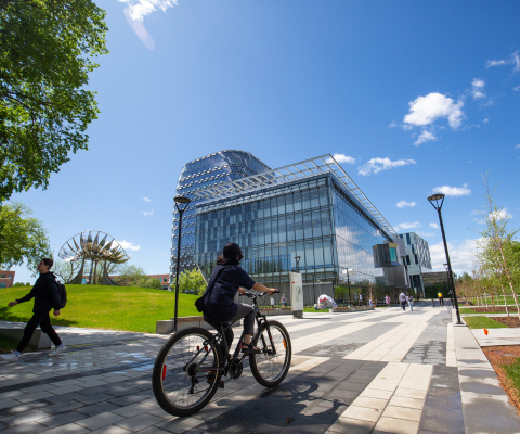 Student biking through a campus