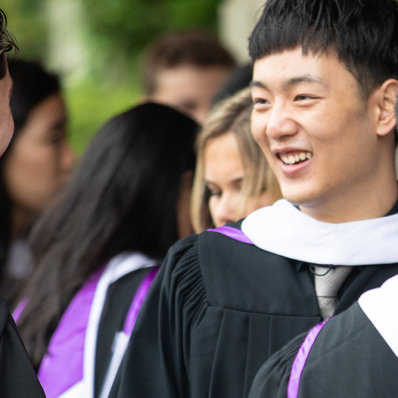 Students talking with each other in graduation convocation