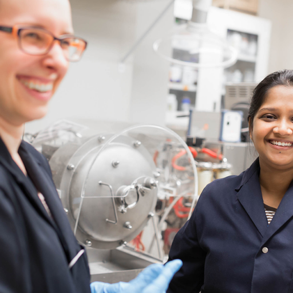 Two students in laboratory smiling