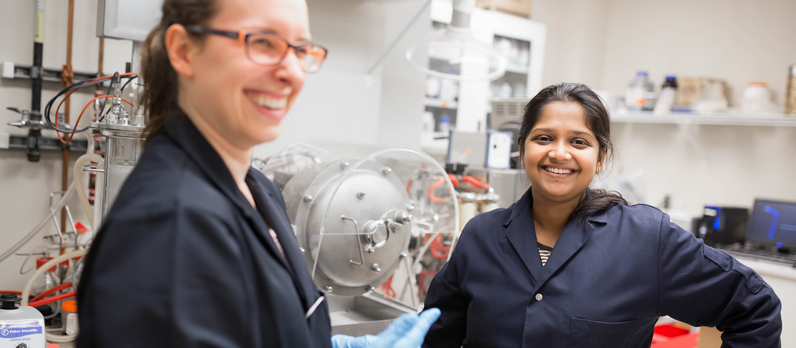 Two students in laboratory smiling