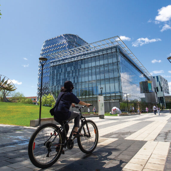 Student riding bike on University campus