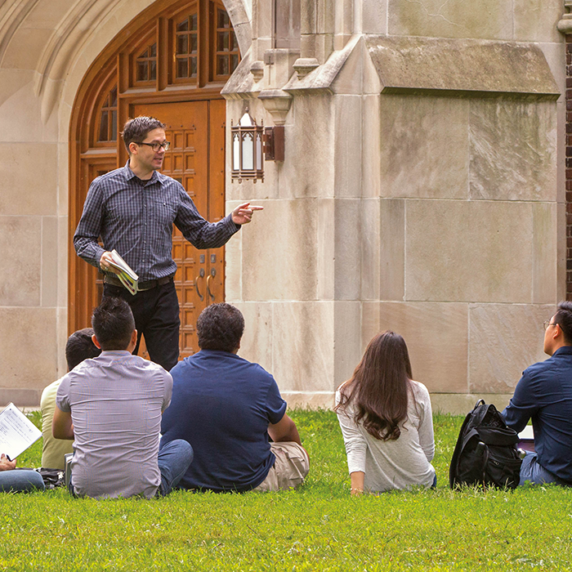 Teacher giving lecture to students on university Garden