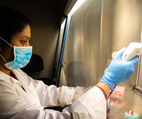 Student working in a lab with mask and gloves