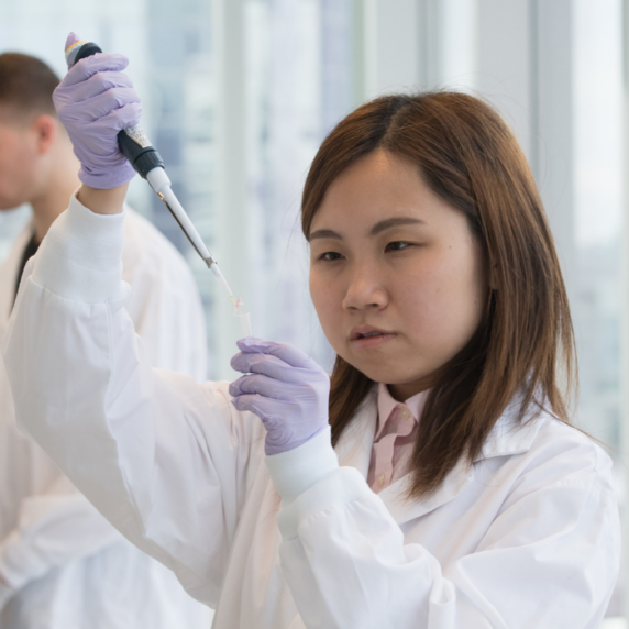 Students in lab coats working at Ryerson research Lab