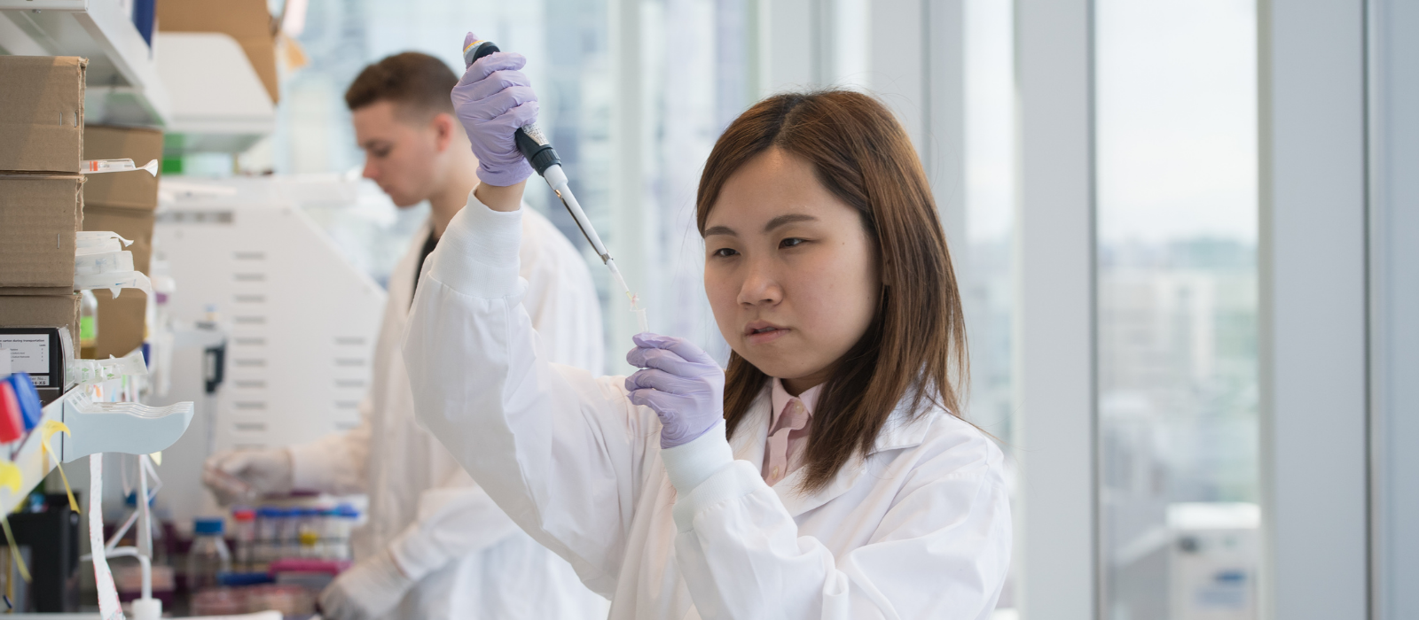 Students in lab coats working at Ryerson research Lab