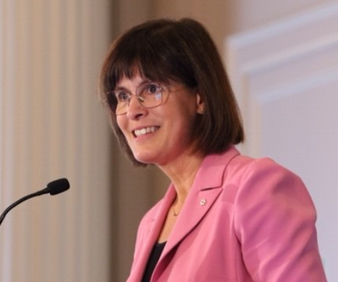 Sophie D'Amours speaking at a podium