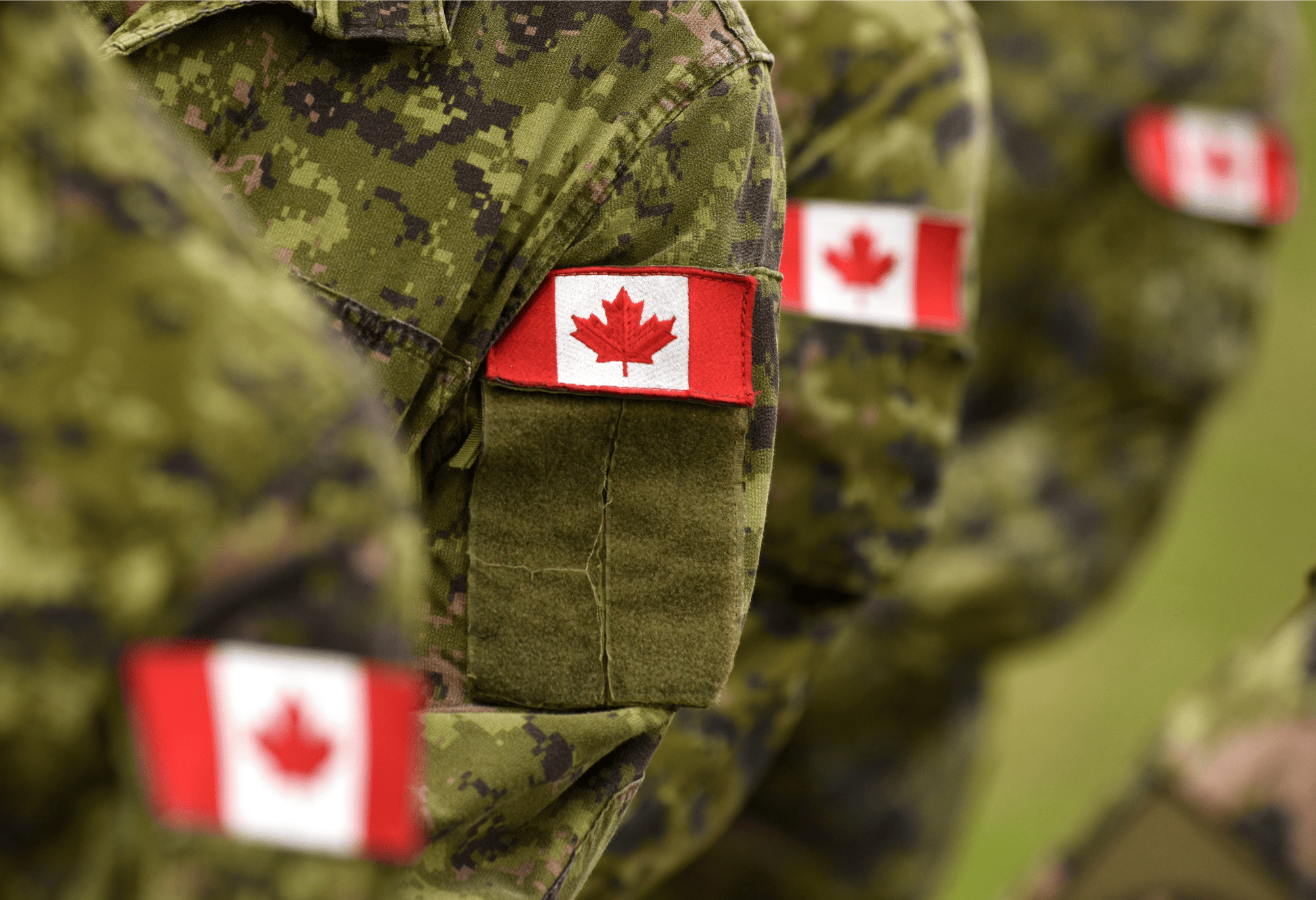 Photo of military fatigues with Canadian flag patches.