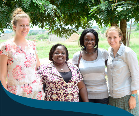 Students for Development interns with two locals in Africa.