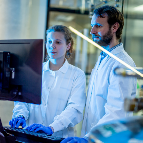 Two researchers working on a computer