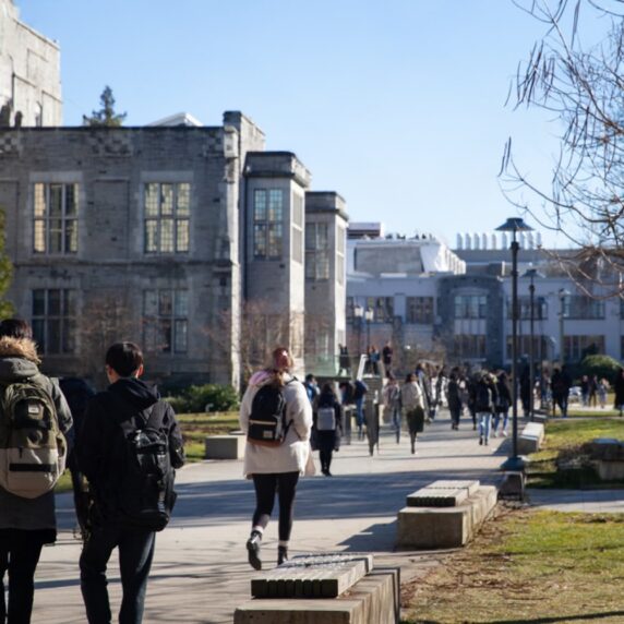 Students walking with backpack on campus