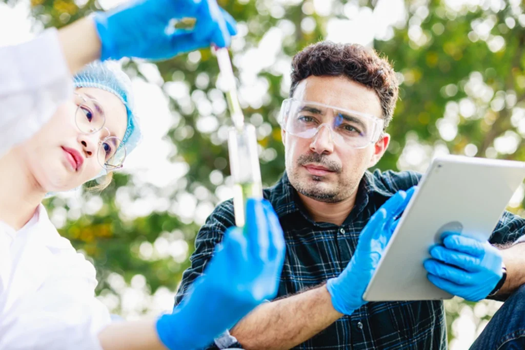 Scientists biologists analyze and test sample water at an industrial estate.