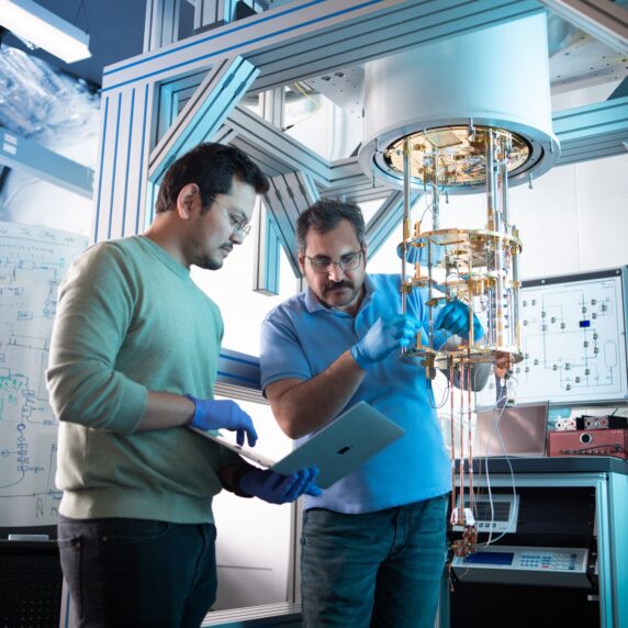 Two quantum researchers working in a lab at the University of Calgary.