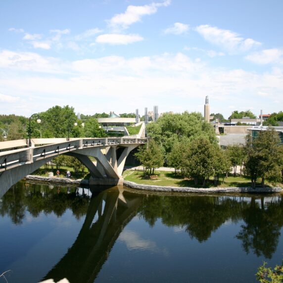 Photo of a bridge and campus building at Trent University.
