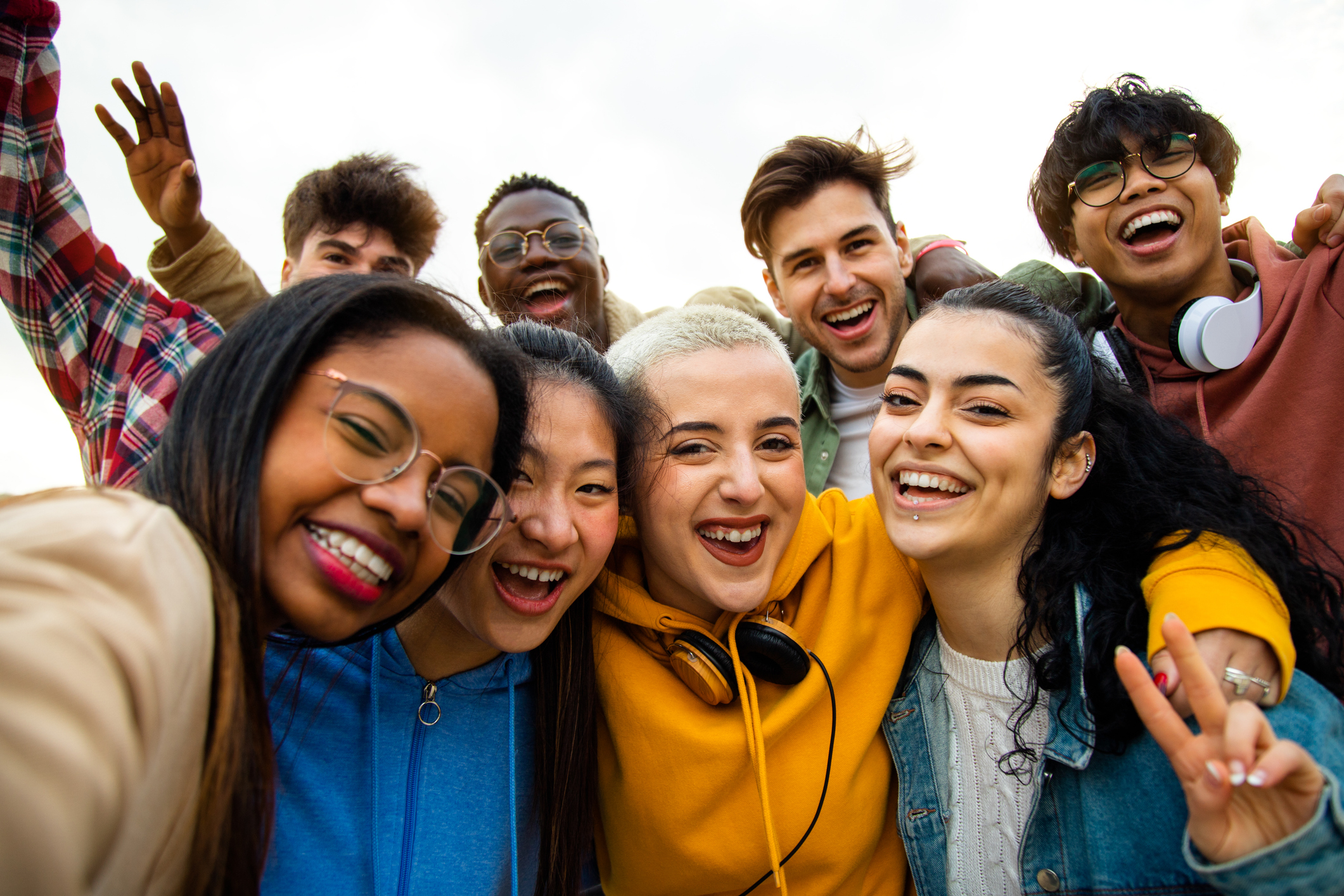 A diverse group of happy students taking a selfie together.