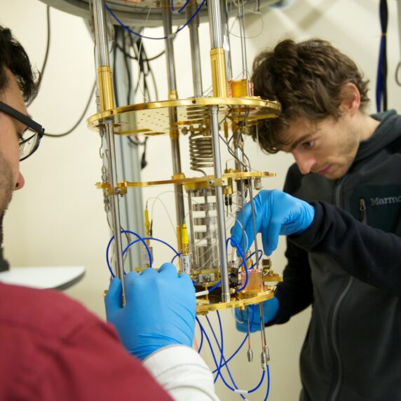 Photo of two students working in a quantum signal processing lab.
