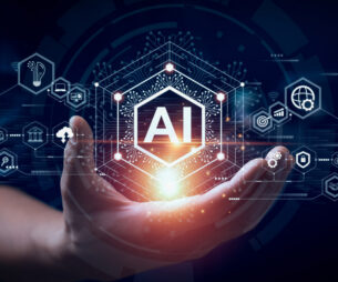 Illustration showing a hand holding a glowing ‘AI’ symbol, surrounded by digital icons representing artificial intelligence and data technologies.